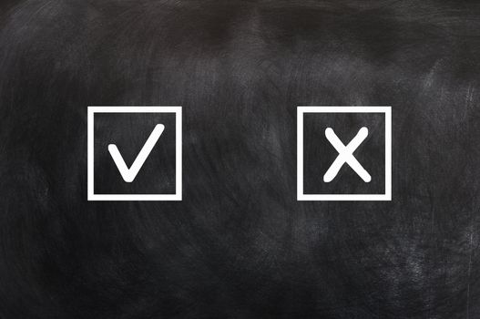 Check boxes with tick and cross on a blackboard