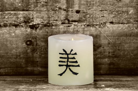 a candle on wooden background