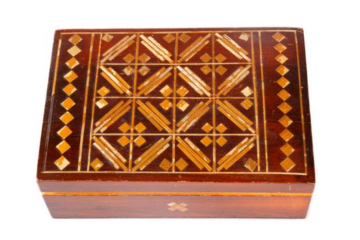 an old wooden  jewelry box with ornaments on a white background