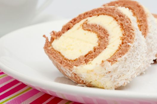 Swiss Sponge Roll With Cream on White Plate