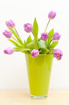 Pink Tulips Bouquet in Green Glass Vase on Wooden Table