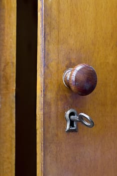 an old iron key in the lock of the door