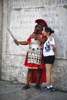 TOURIST AND SOLDIER, ROME, ITALY, SEPTEMBER 26, 2011: Street performer dressed like Roman soldier offer photo sessions to tourists near the Spanish steps - Rome.