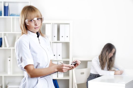 portrait of doctor, holds a tablet in the office