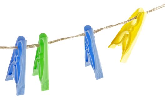 Four colour Clothespins on linen store isolated