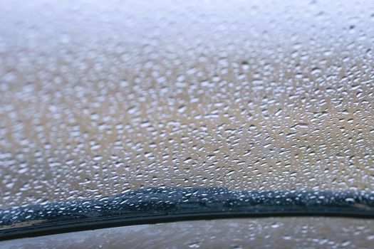 View of rain on a windshield with a wiper blade from the inside
