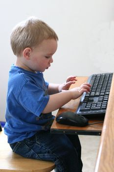 Young boy "working" at the computer