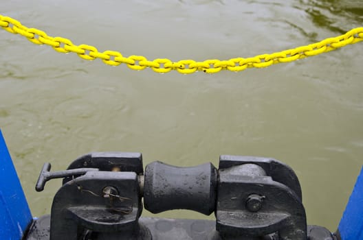 Ferry berthing mechanism closeup background. Yellow protective chain.