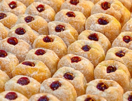 Ready-made donuts covered with powdered sugar on a tray