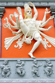 Hindu Goddess with Many Arms  Holding Weapons Statue on Wall of Sri Senpaga Vinayagar Temple