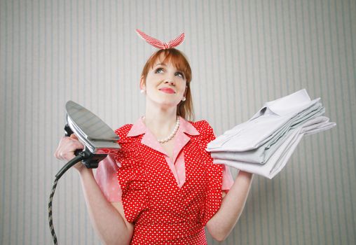 Perfect housewife with iron and ironed shirts