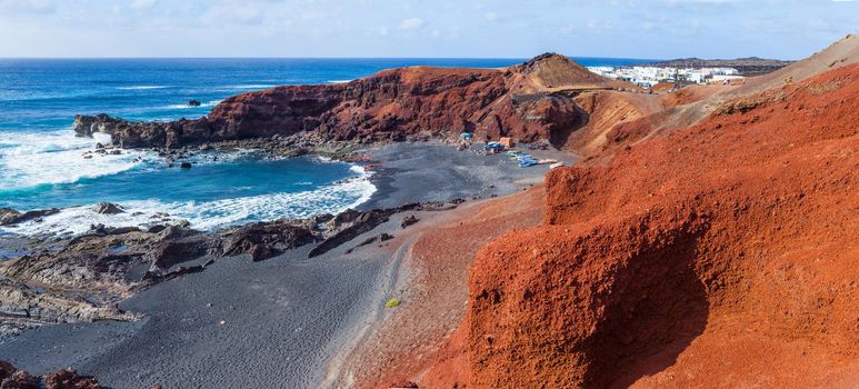 Exotic beach with black sand red rocks on Lanzarote, Canary islands, Spain. Panorama