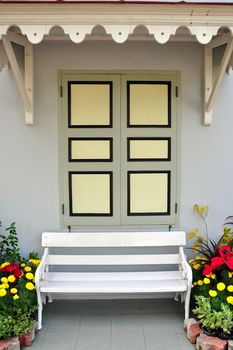 A picture of White chair against window and wall