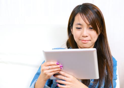 young asian woman using tablet computer