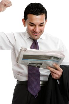 A businessman reading the newspaper, punches the air with a fist of excitement.  Please note newspaper editorial has been blurred beyond comprehension.  White background.