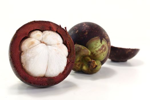 cut mangosteen fruit on a light background