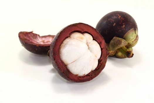 fresh cut mangosteen fruit on a light background