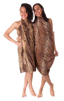 Two barefoot girls in animal print isolated on white background