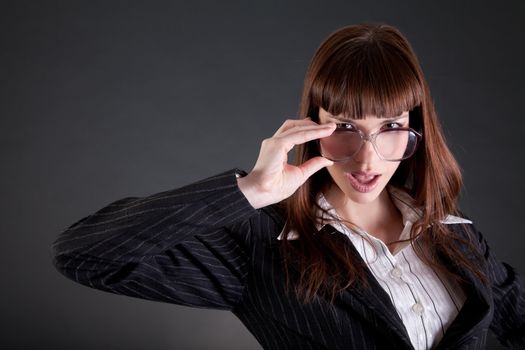 Businesswoman in old fashioned glasses, studio shot 