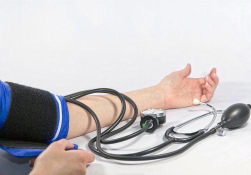 Woman's arm and blood pressure sphygmomanometer
