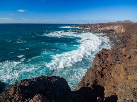 Storm at Sea. View through rocks on coastline of beach of sea