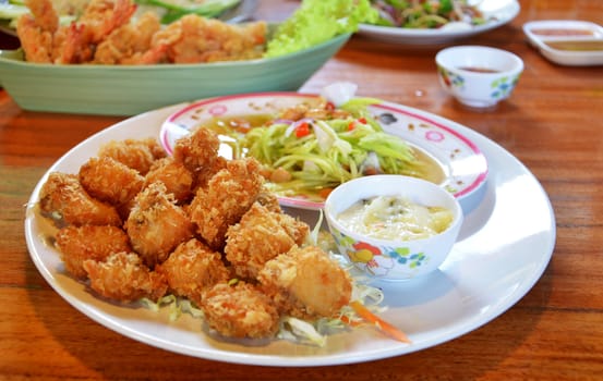 deep fried fish served with spicy salad and cream sauce