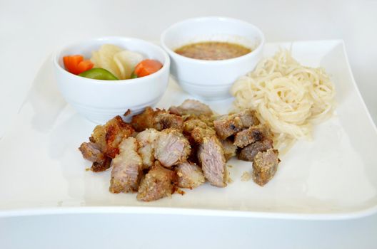 grilled pork served with sweet sauce and vegetable , noodle