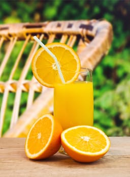 orange juice in a glass on a table with oranges