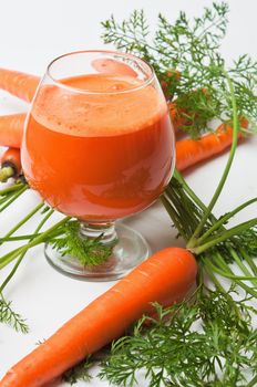 carrots and carrot juice in a glass