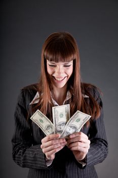 Laughing business woman with dollars, studio shot 