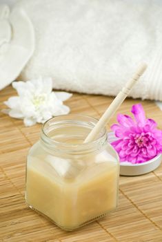 relaxing aroma of almond coconut vanilla milk and honey bath foam over wooden mat