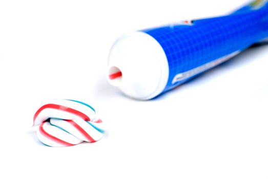 white red and blue squeezed toothpaste isolated on a white background