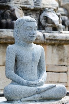 Buddha stone statue in a meditation pose