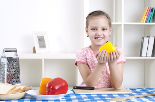 beautiful young girl cooking vegetables for a salad, working in kitchen