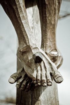 Feet of a wooden jesus christ on the cross