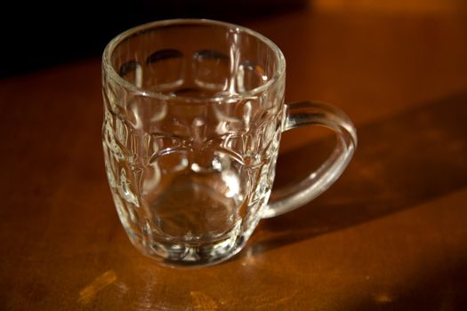 Empty beer mug over wood background 