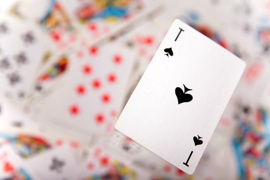 Close-up up of a spades ace over blurred card background 