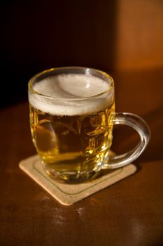 Beer mug on a coaster with blank space for your label  