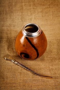 Argentinean Calabash with Bombilla over canvas background, selective focus 