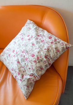 White pillow roses painted on Orange leather sofa