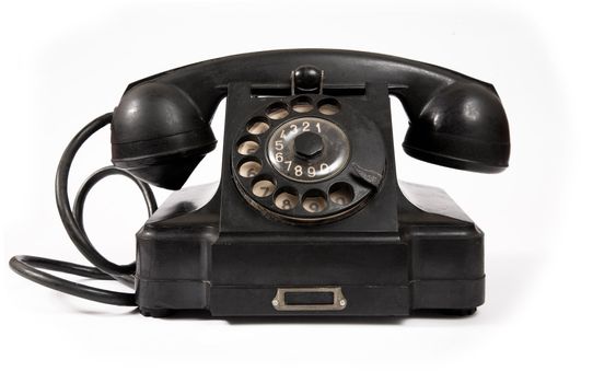 Old black phone with dust and scratches, isolated on white background 