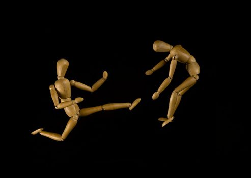 Two puppets fighting, isolated on black background 