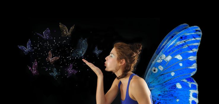 Fairy with blue wings blowing butterflies, isolated over black