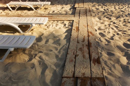 Evening at the beach, row of beach chairs 