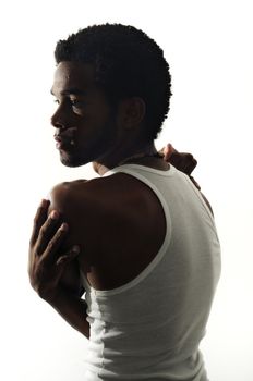 Low key portrait of young african american man posing isolated on white