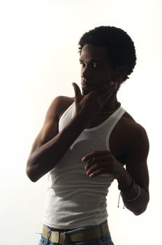 Low key portrait of young african american man posing isolated on white