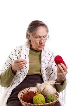 Senior lady sitting on her chair knitting