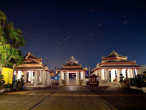 Chinese style pavilion in Wat Arun(Temple of Dawn) with star trails above the Bangkok city, Bangkok, Thailand