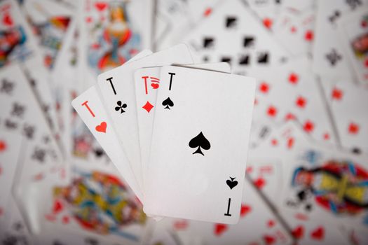 Close-up up of a four aces over blurred card background 