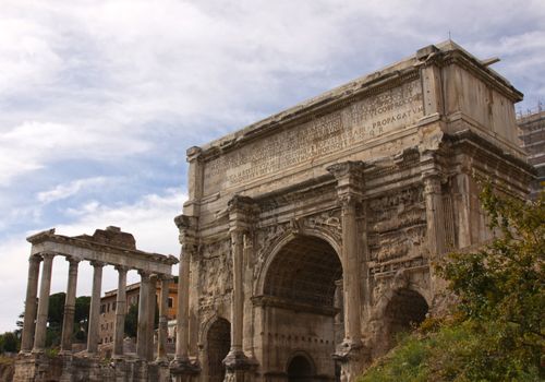 The Arch of Septimius Severus with the Temple of Saturn, in the background in the Roman Forum in Rome, Italy.